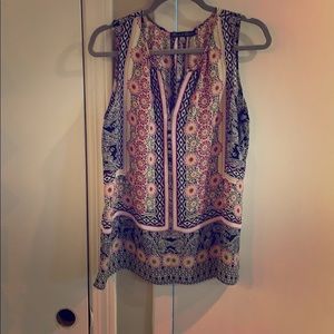 Black and floral sleeveless blouse. Polyester.